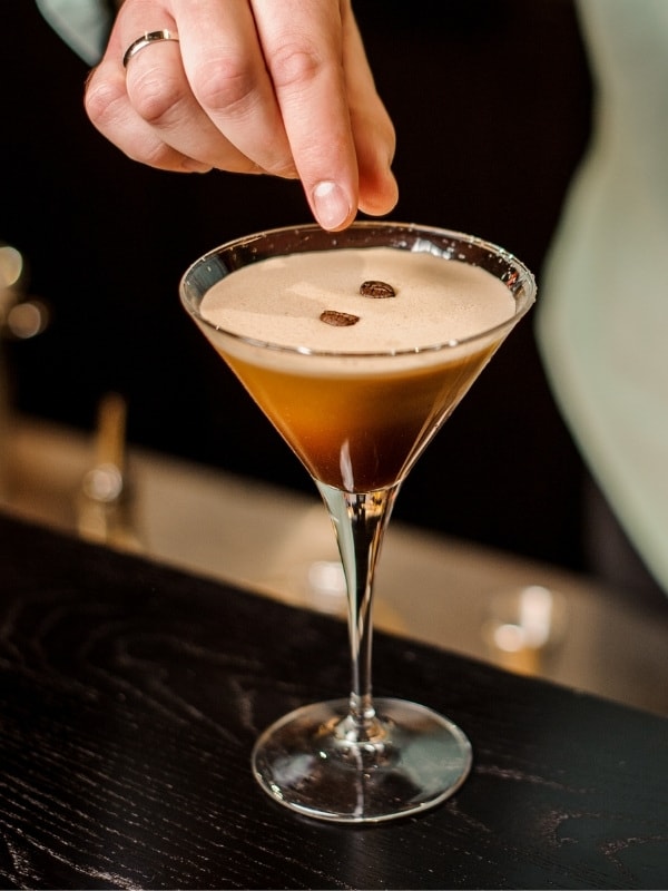 Topping an Espresso Martini with coffee beans