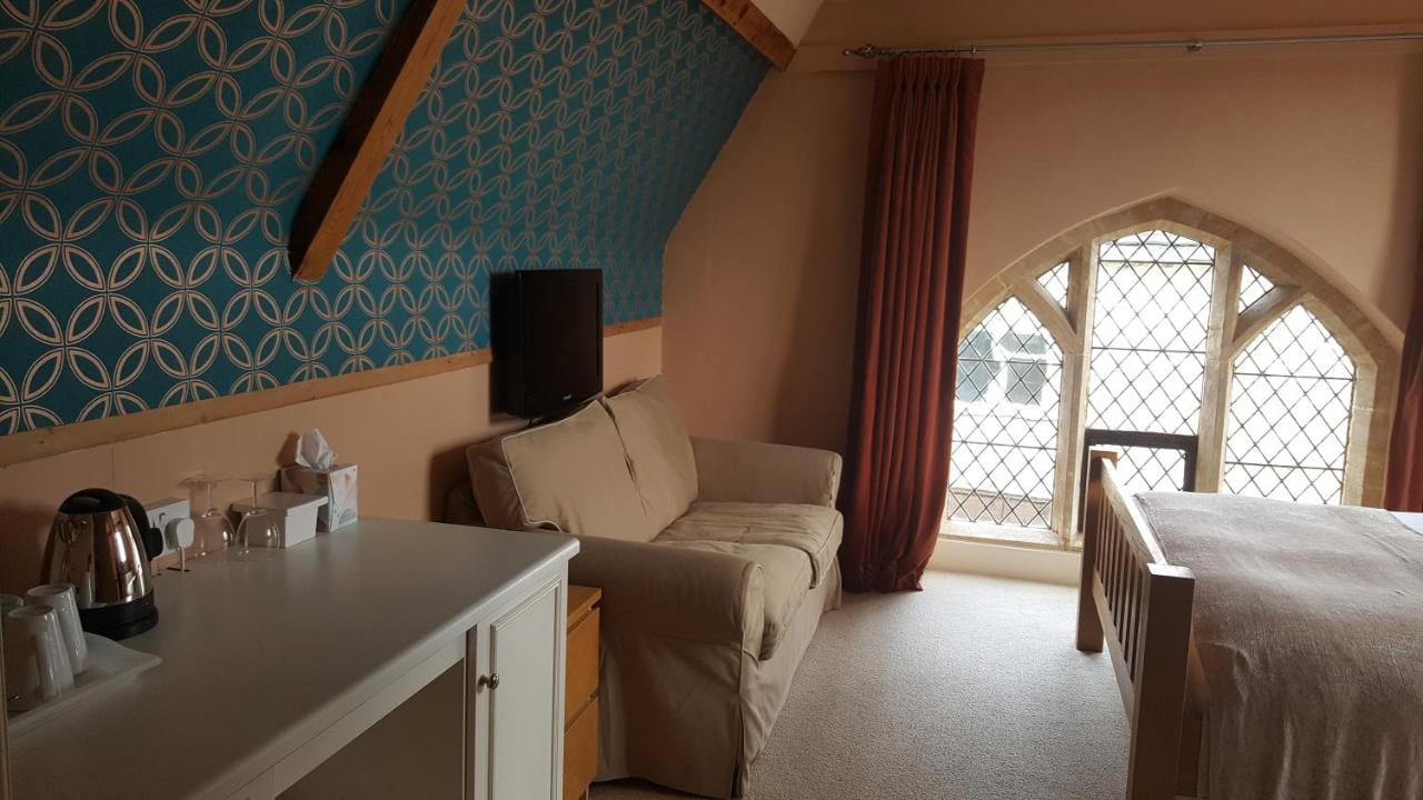 Bedroom with stained glass windows at The Belfry